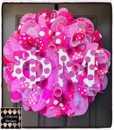 a pink and white wreath with the word d is for love written in large letters