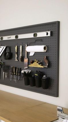 a pegboard with many tools hanging on it