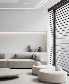 a modern living room with white furniture and large window blinds on the windowsills