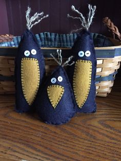 two blue stuffed animals sitting on top of a wooden table