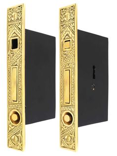 two black and gold door handles with an ornate design on the front one has a keyhole