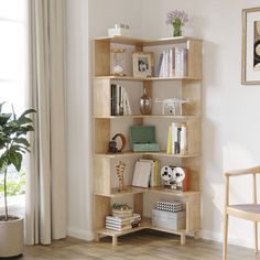 a living room with a book shelf filled with lots of books and plants next to a window