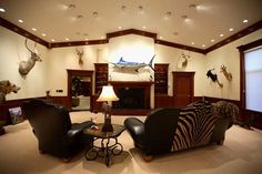 a living room filled with furniture and deer heads on the wall