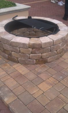 a brick fire pit sitting on top of a patio