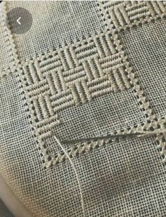 a close up view of a piece of cloth with stitching on it and some thread in the middle