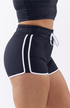 You will move with ease from land to sea in these stretch-enhanced swim shorts topped with a high waist. 3 1/2" inseam   Lined   80% recycled polyester; 20% spandex   Hand wash, line dry   Imported Moisture-wicking High-waisted Shorts For Beach, Black Swimwear With Built-in Shorts, High-waisted Swim Shorts With Elastic Waistband, Stretch Athleisure Athletic Shorts For Beach, Beach Athleisure Stretch Athletic Shorts, High-waisted Athletic Shorts With Built-in Shorts For Beach, Stretch Swim Trunks For Workout During Beach Season, Sporty Yoga Bottoms For Beach Season, High-waisted Moisture-wicking Shorts For Beach