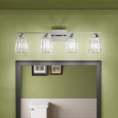 a bathroom vanity with three lights and a mirror