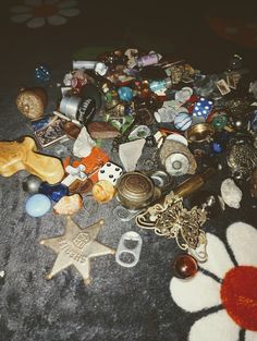 a pile of assorted items sitting on top of a carpet