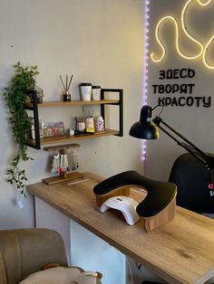 an office with a desk, chair and shelves on the wall in front of it