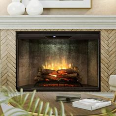 a living room with a fire place in the center and a coffee table next to it