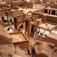 an aerial view of a village in the desert with lots of mud houses and buildings