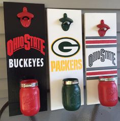 three green bay packers bottle openers are hanging on the wall next to each other