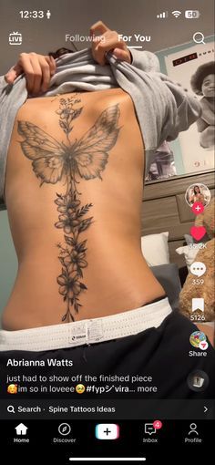 the back of a woman's body with tattoos on her stomach and an image of a butterfly