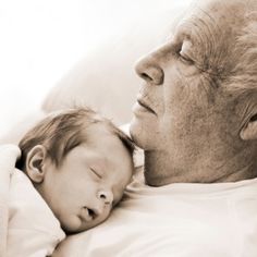 an older man holding a sleeping baby in his lap with the caption, the value of getting on with your life