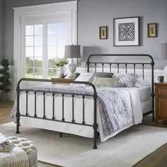 a bedroom with gray walls and white bedding