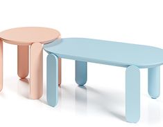 three different colored tables sitting next to each other on a white surface, one is blue and the other has pink