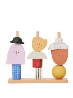 three wooden people standing next to each other