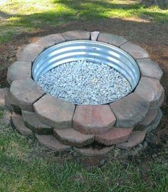 an outdoor fire pit with gravel in it