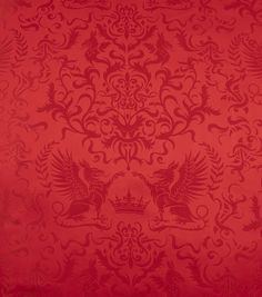 a red wallpaper with an ornate design on it