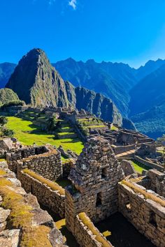 the ruins are surrounded by mountains and grass