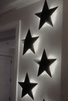 five black stars are hanging on the wall