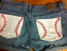 a pair of jean shorts with baseball stitching on them