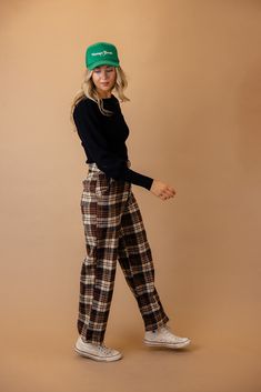 These pants feature a classic plaid pattern with a high-rise waist for a flattering fit. The four-pocket design adds functionality to fashion, and the fleece exterior ensures warmth and coziness. Elevate your winter wardrobe with these versatile and chic plaid pants. zip-fly with button closure function pockets unlined // paired with the Beverly balloon sleeve sweater in black + the vintage goods foam trucker hat *FINAL SALE* Retro Straight Leg Pants For Fall, Fall Retro High-waisted Pants, Retro High-waisted Pants For Fall, Retro Winter Trousers, Black Retro Fall Pants, Retro Plaid Pants For Fall, Brown Cargo Pants For Winter, Winter Brown Cargo Pants, Cozy Cotton Pants For Fall