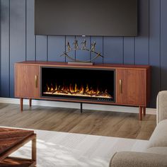 a living room with a fireplace and tv on the wall in front of blue walls