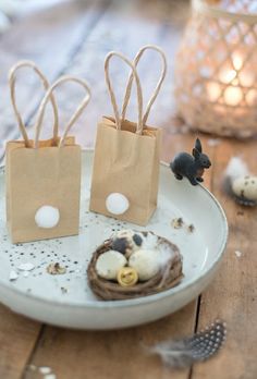 two small bags are sitting on a plate with some eggs in it and one bag is empty