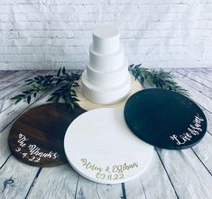 three wooden wedding cake plates with names on them