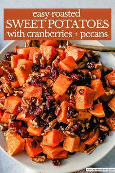 sweet potatoes with cranberries and pecans in a white bowl on a table