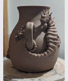 a clay vase sitting on top of a table