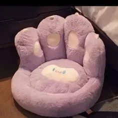 a stuffed animal chair sitting on top of a wooden floor