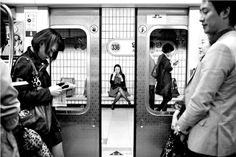 people are standing on the subway platform and waiting for their train to pass them by