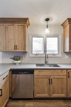 a kitchen with wooden cabinets and stainless steel appliances in the center, along with a dishwasher