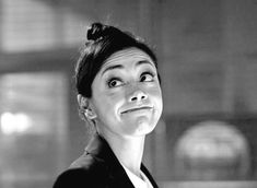 a black and white photo of a woman making a funny face