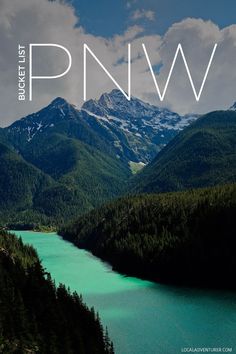 a lake surrounded by mountains with the word pnw over it's image