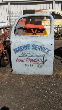 an old boat repair truck is parked in front of a building with chairs on it