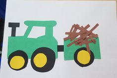 a paper cut out of a tractor with the letter t on it