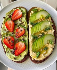 a sandwich with avocado, strawberries and other toppings is on a plate