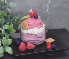 an ice cream sundae with raspberries, blueberries and strawberries in it