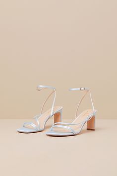 Keep things chic and simple by adding the Lulus Kierha Baby Blue Satin Strappy Low Heel Sandals to any of your effortlessly elegant 'fits! Sleek woven satin shapes these darling heels that feature a square footbed, two slender two straps, and an asymmetrical vamp strap. Matching straps sprout from the sides to cross at the front of the ankle and secure with a gold buckle, all atop a trendy blade heel. 2. 75" wrapped blade heel. Cushioned insole. Felted rubber sole has nonskid markings. Man made Blue Bridal Shoes Low Heel, Dusty Blue Heels Wedding, Strappy Sandals For Spring Prom, Strappy Sandals For Prom In Spring, Strappy Heels For Summer Events, Spring Prom Strappy Sandals, Satin Sandals For Summer Events, Satin Sandals With Wrapped Heel And Open Heel, Low Heel Satin Sandals For Spring