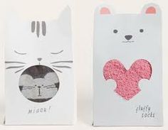 two paper bags with cats on them and one has a heart in the shape of a cat