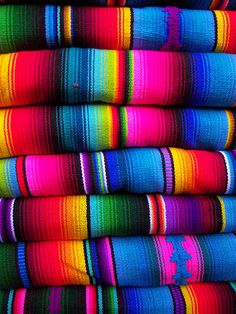 a pile of colorful towels stacked on top of each other