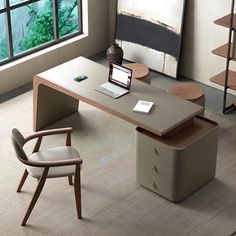 an office desk with a laptop on it in front of a large window and bookshelf