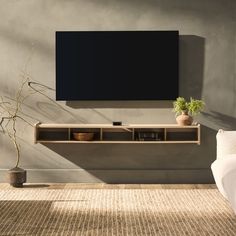 a living room scene with focus on the entertainment center and wall mounted flat screen tv