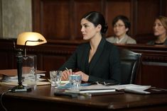 a woman sitting at a table in front of two other women