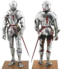 two metal figurines of knights standing on wooden bases