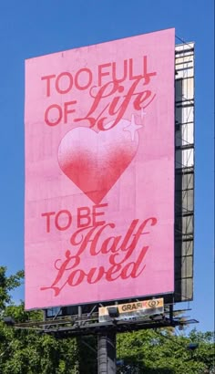 a large pink billboard with the words too full of life to be ugly loved on it