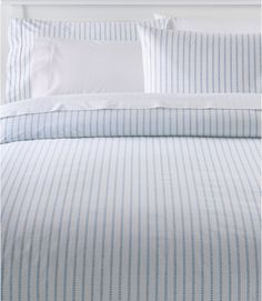 a bed with blue and white striped sheets